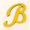 A yellow 3D acrylic letter B wall sticker with a black outline.