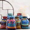 A set of ten vintage cotton drawstring gift pouches in various colorful patterns and textures.