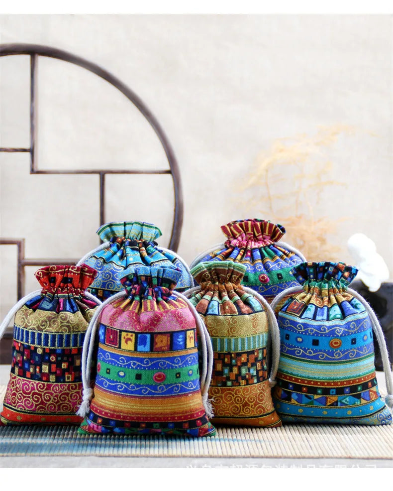 A set of ten vintage cotton drawstring gift pouches in various colorful patterns and textures.