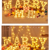 Warm white LED alphabet letter lights spelling out MARRY in a festive setting