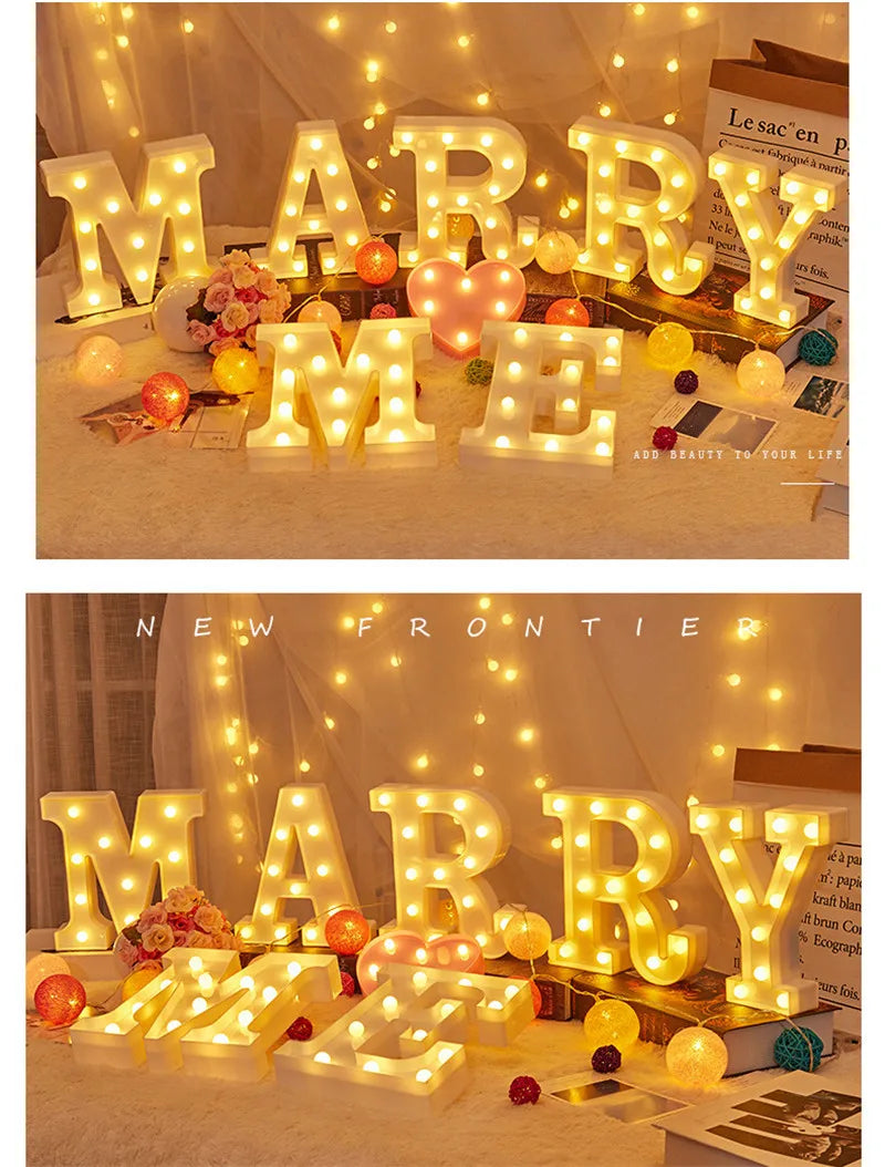 Warm white LED alphabet letter lights spelling out MARRY in a festive setting