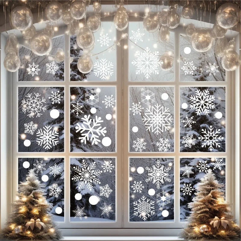 Window decorated with snowflake clings and warm string lights framing a snowy winter scene.