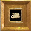 A framed painting featuring a white swan on a black background, set in an elegant gold frame.