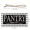 A black rectangular sign with a checkered pattern and the word PANTRY and Open 24/7 in white script, accompanied by a natural