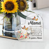 A clear heart-shaped ornament featuring floral designs and text in Spanish expressing love for Mom