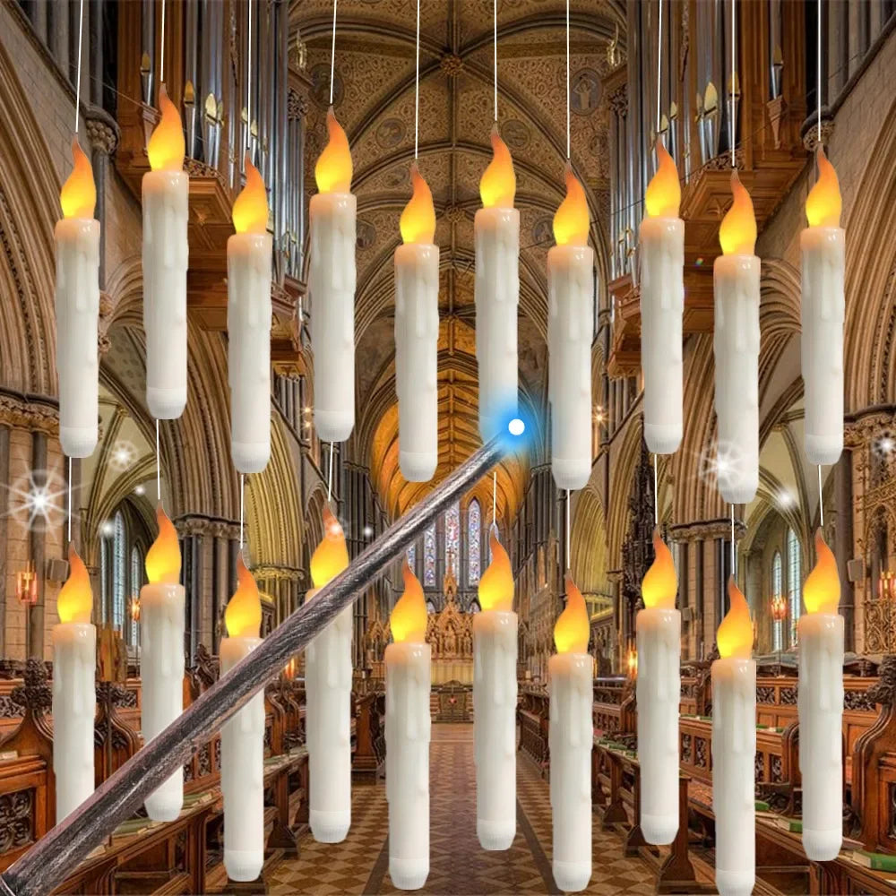 A display of glowing white LED floating candles suspended by wires, with a magic wand visible in the foreground.