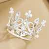 A delicate silver crown made of clear crystals and pearl accents, suitable for cake toppers.