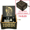 A wooden music box with a lid featuring a stylized wolf design and intricate patterns.