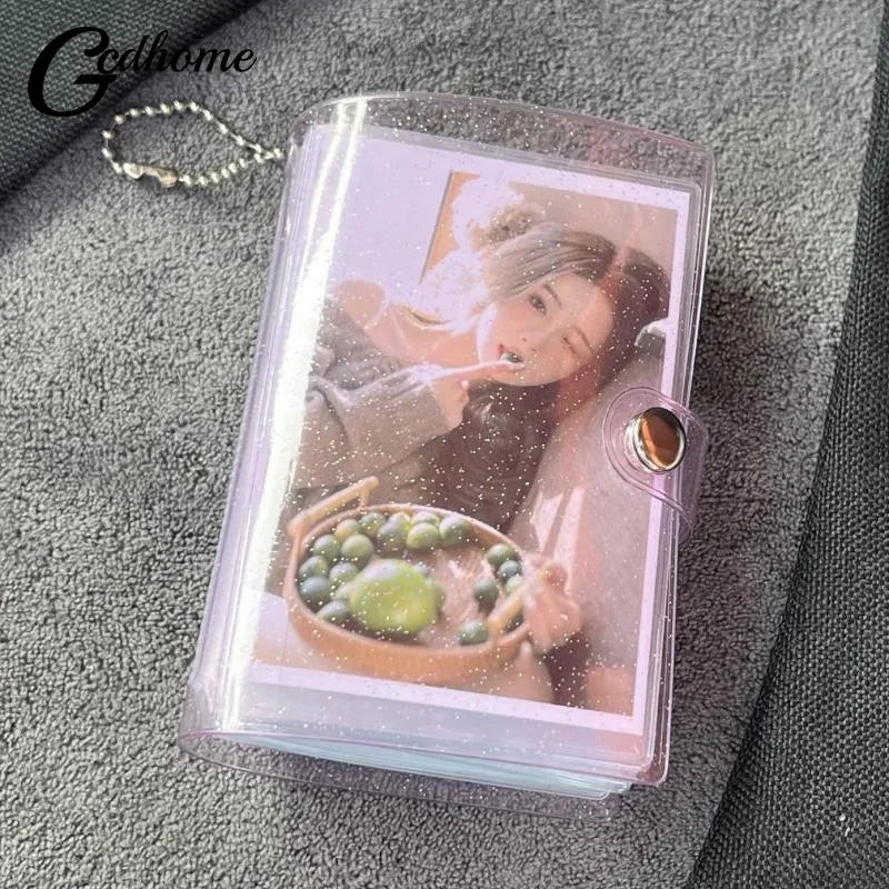 A clear plastic photo album featuring a portrait of a person and a bowl of green fruit on a gray fabric background.