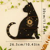A black silhouette of a cat with gold accents and stars, displayed on a white background.