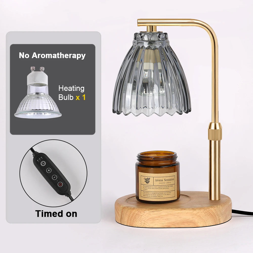 A gold-toned adjustable candle warmer lamp with a glass shade and a wooden base, next to instructions.