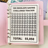 A pink binder for a 100 envelope savings challenge tracker with numbered pockets.
