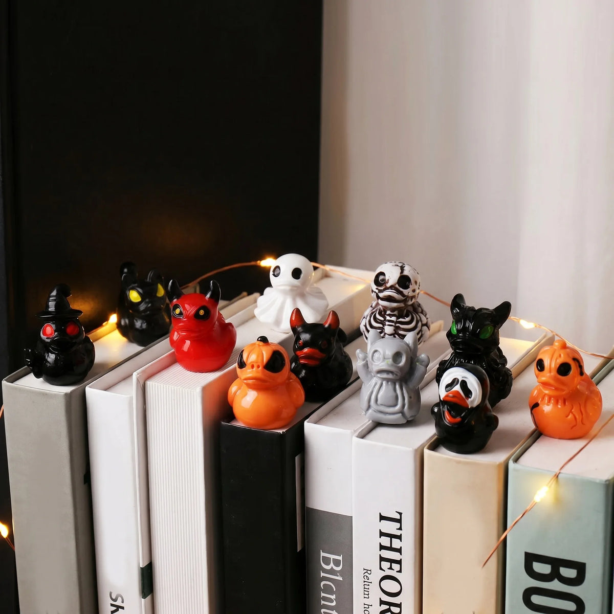 A collection of twelve mini resin Halloween duck figurines in various colors and designs displayed on a shelf.