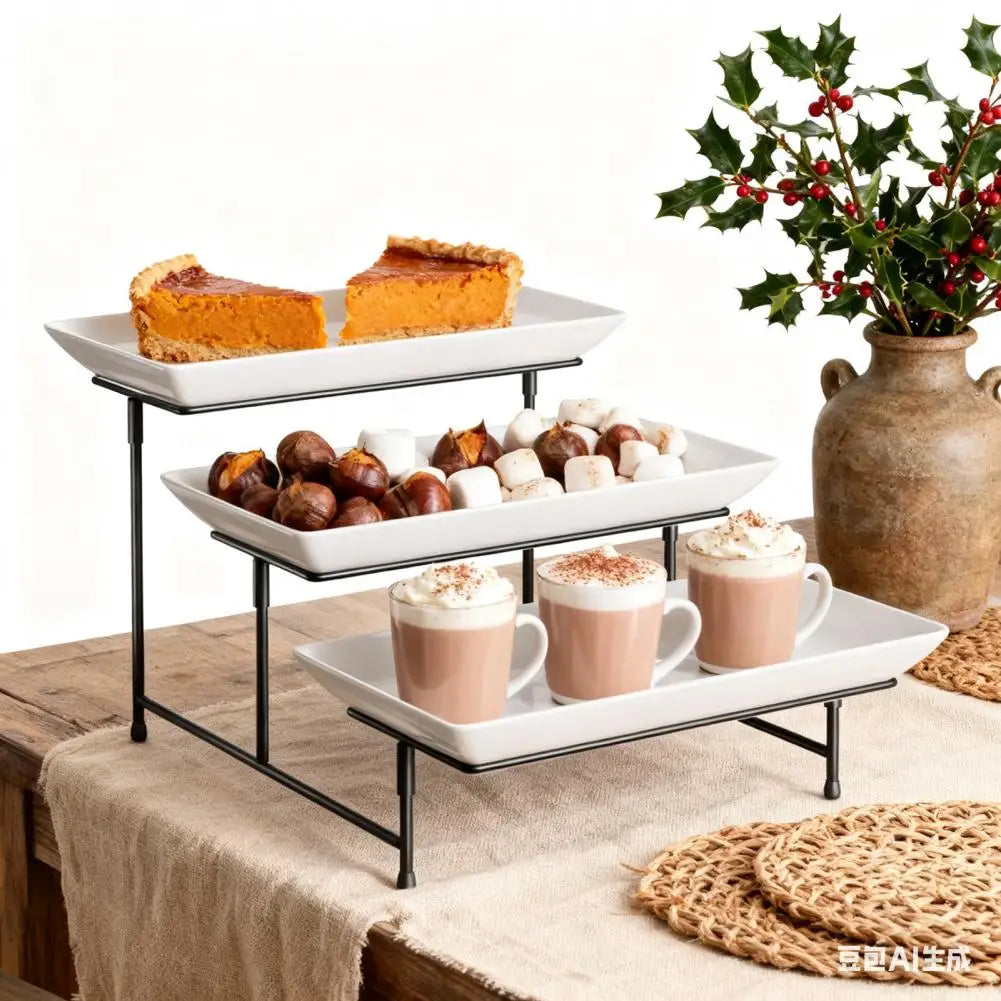 A black metal three-tier serving rack displaying baked goods and beverages on a wooden surface.