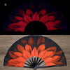 A folding fan with an orange and black floral design, shown in a semi-open, fan-like shape.