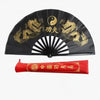Black traditional bamboo folding fan decorated with gold dragon motifs and Chinese characters