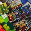 A collection of official stickers and memorabilia related to the 2026 FIFA World Cup, featuring various national teams and ev