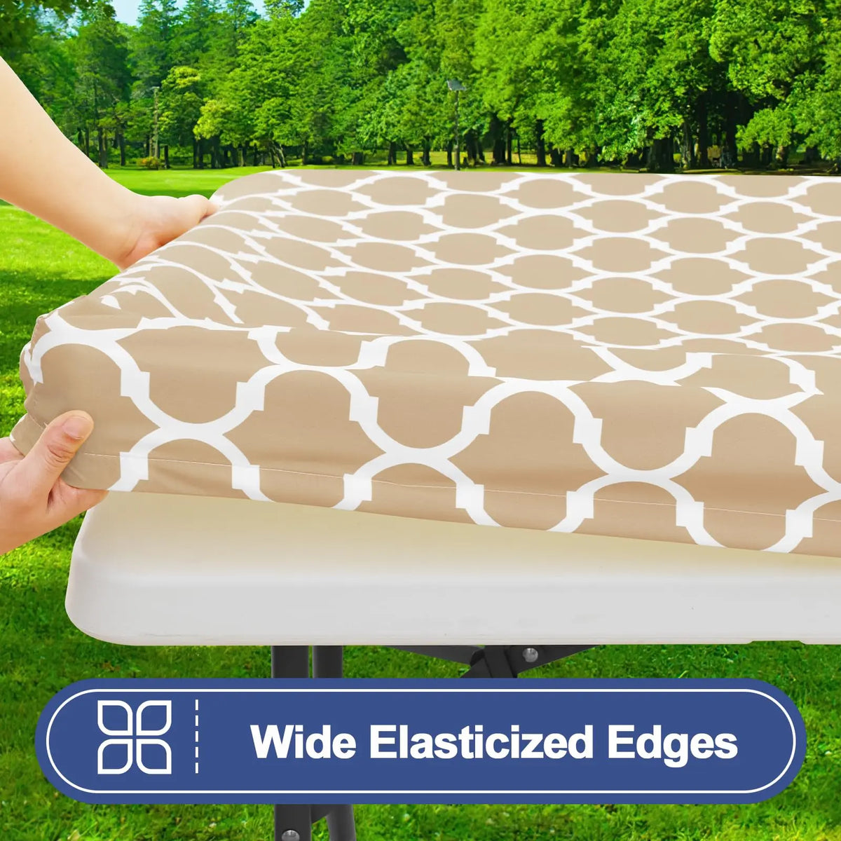 A beige waterproof elastic fitted tablecloth is being placed on a folding table outdoors.