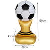 A standing soccer balloon featuring a black and white football on top, supported by a gold base.