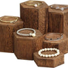 Wooden hexagonal display rack holding various gold and silver jewelry and accessories
