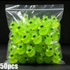 A clear plastic bag filled with fifty glow-in-the-dark resin charms shaped like alien cats and ducks.