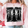 Pink sweatshirt featuring a black and white graphic of four witches standing together with the text Girls Will Be Girls.