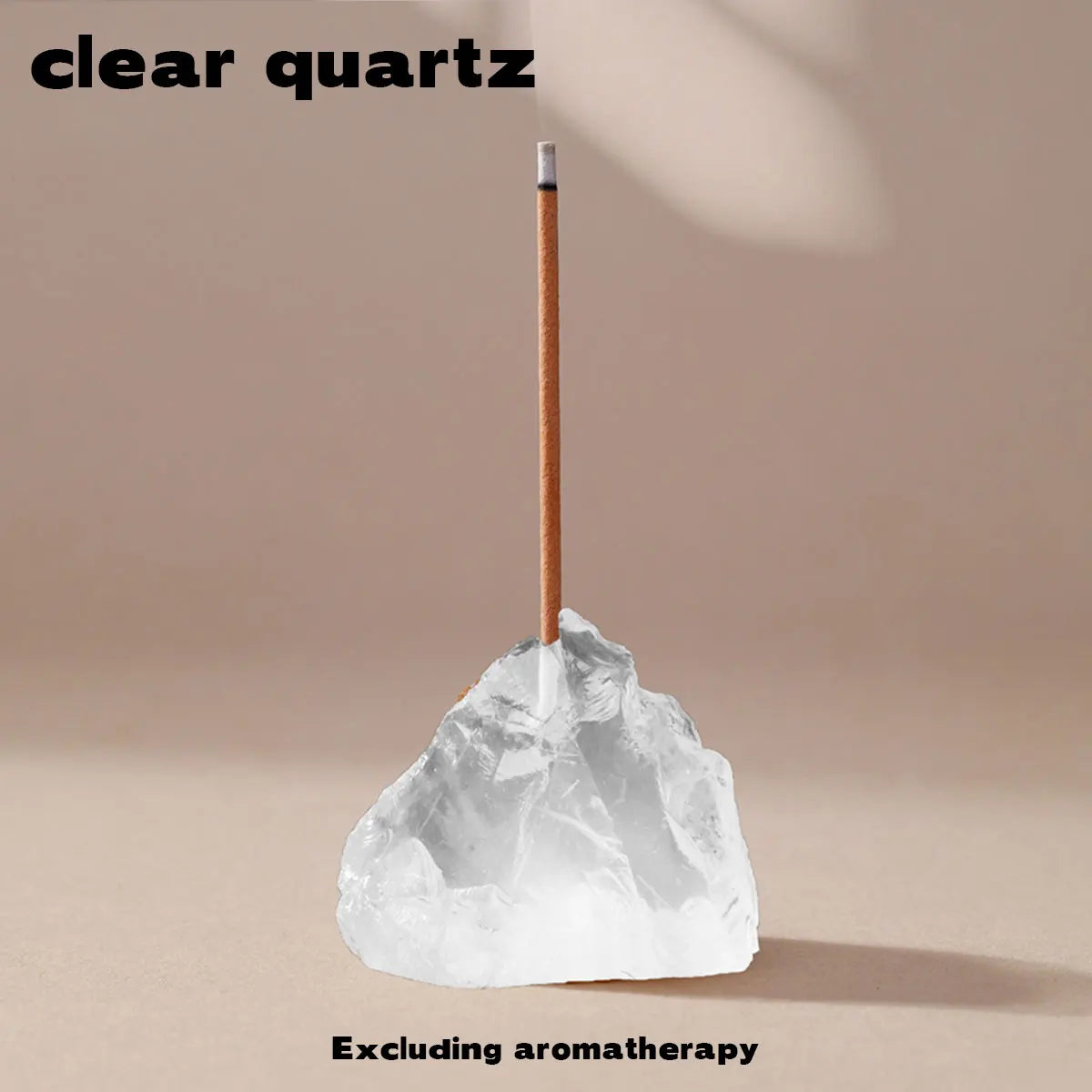 A clear quartz point rests on a rough, translucent stone with a wooden stick, excluding aromatherapy.