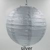 A spherical silver decorative paper lantern hanging from a string.