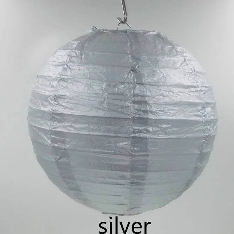 A spherical silver decorative paper lantern hanging from a string.