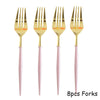 Eight pieces of gold forks with pink handles for a party table setting