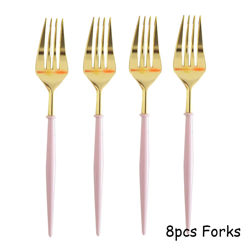 Eight pieces of gold forks with pink handles for a party table setting