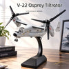 A 1:72 scale model of a V-22 Osprey tiltrotor aircraft displayed on a stand.