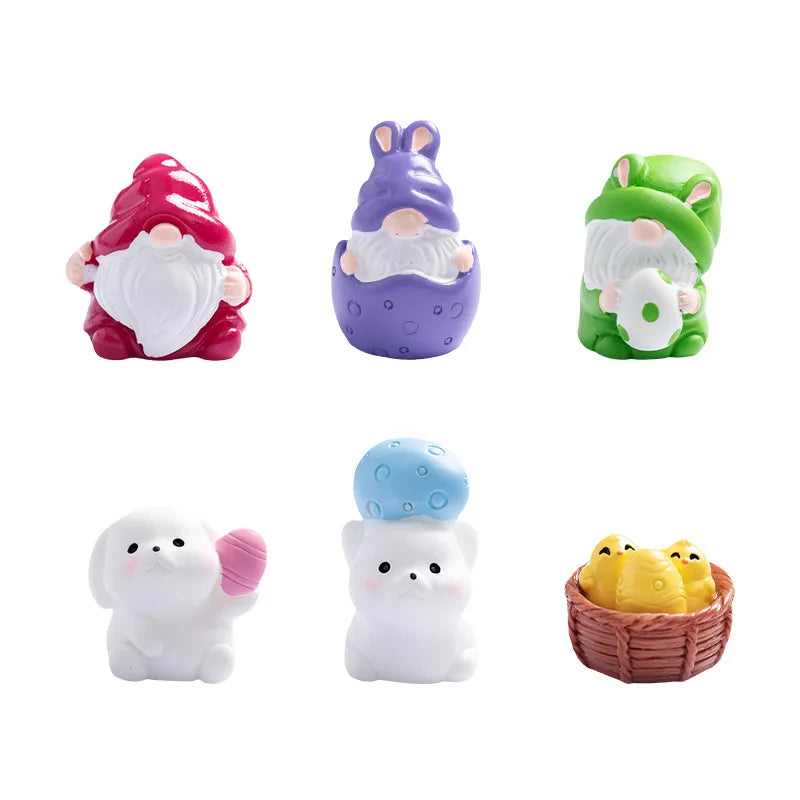 A set of four festive resin Christmas dwarf figurines in pink, purple, green, and white.