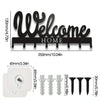 Black decorative metal wall-mounted key holder with seven hooks and a white mounting plate
