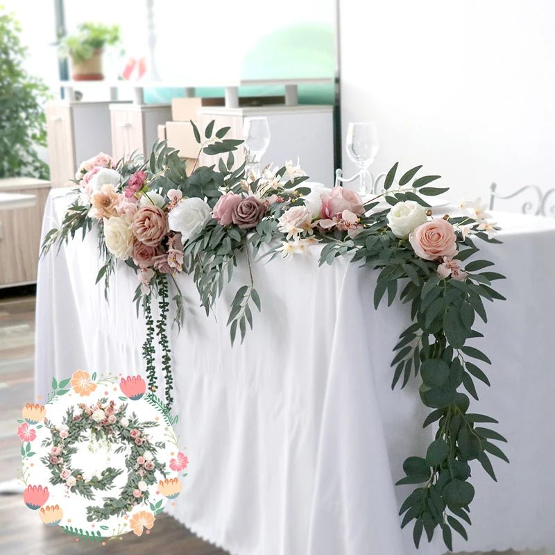 An artificial eucalyptus garland featuring pink, cream, and dusty rose roses used for weddings and events.