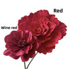 A close-up of a deep wine red artificial peony flower with layered petals.