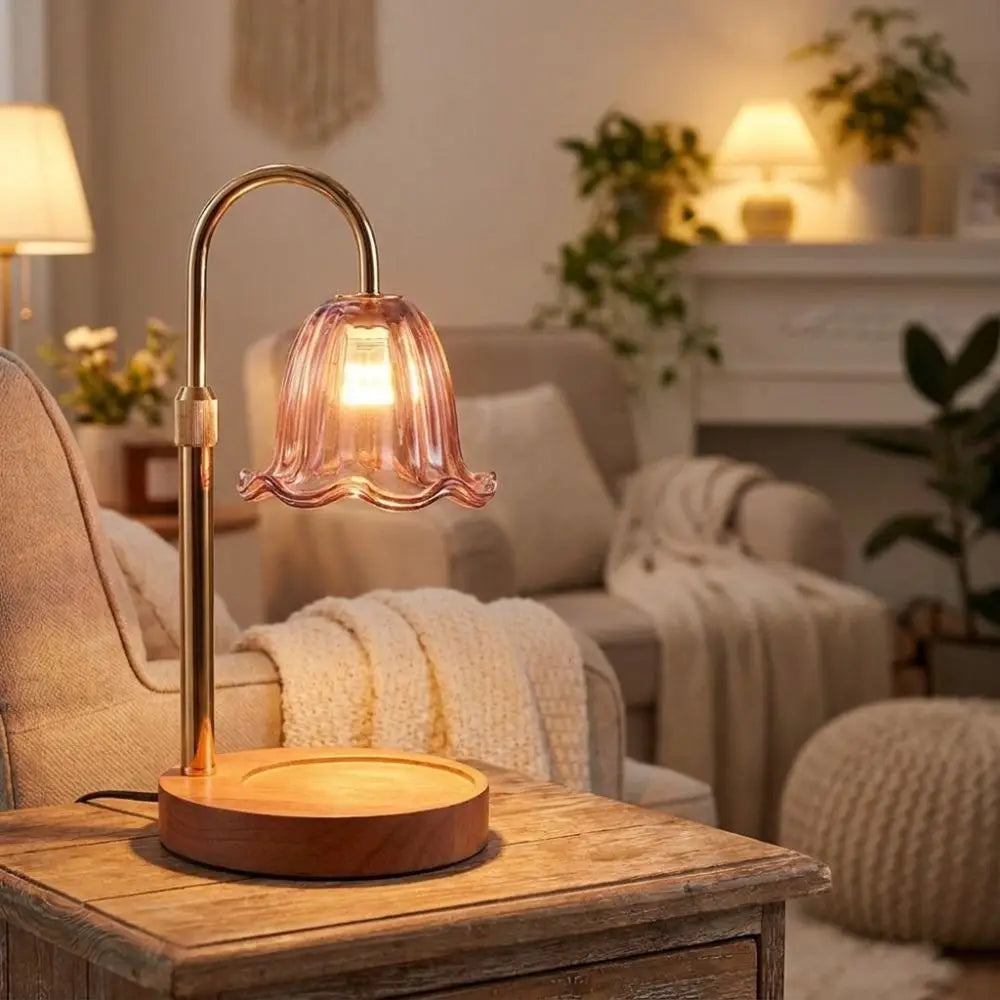 A brass adjustable height aromatherapy candle warmer lamp sitting on a wooden table in a cozy living room.