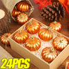 A box filled with 24 golden orange pumpkin hanging ornaments surrounded by pine cones and natural materials.
