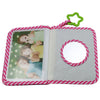 A pink and white striped photo album with a clear cover and a green loop closure.