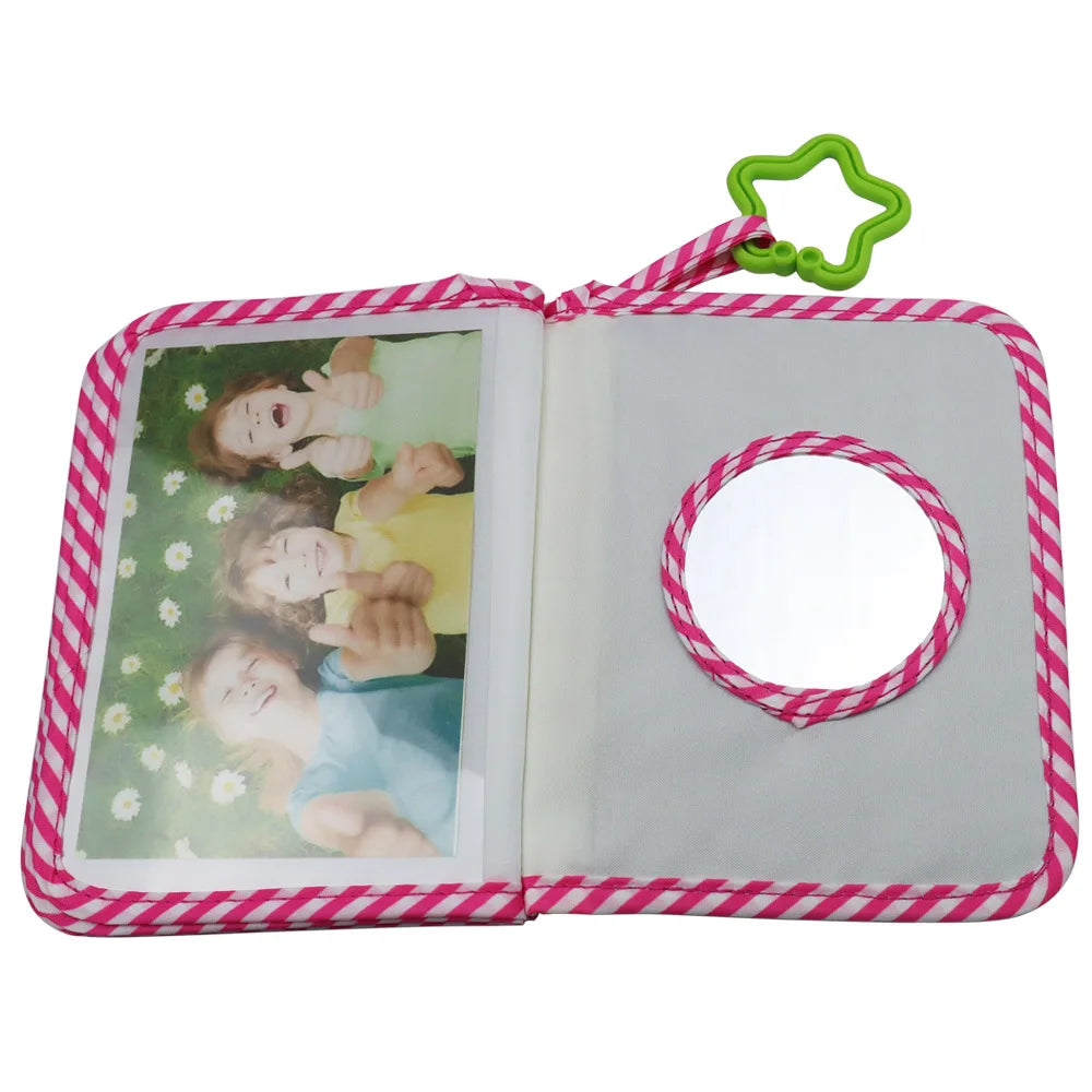 A pink and white striped photo album with a clear cover and a green loop closure.