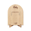 A light wood photo frame with the word Baby engraved on the top and Coming Soon on the bottom.
