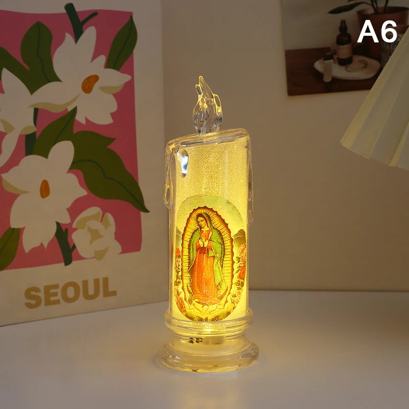 A clear glass flameless LED religious prayer candle with a depiction of the Virgin Mary inside.