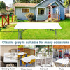 A classic gray outdoor table is set up on a lawn, suitable for various occasions.