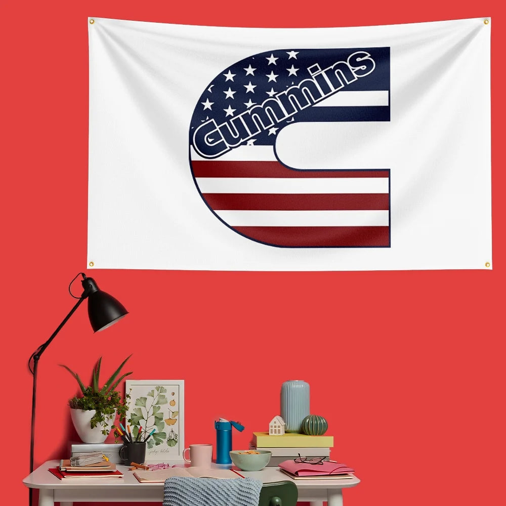 A white flag featuring the Cummins logo in navy blue and red stripes on a red wall.