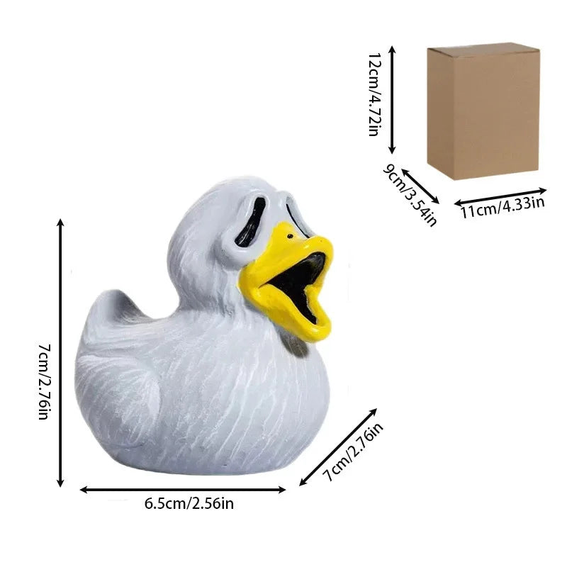 A white resin figurine of a duck with an open mouth and yellow beak, used for spooky decor.