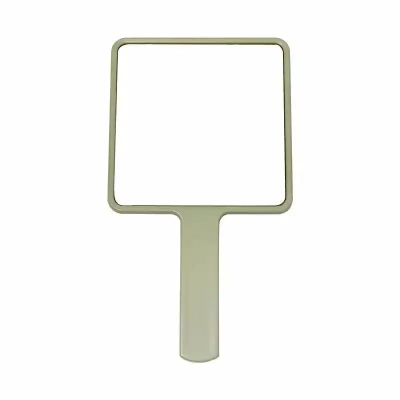 A rectangular, light green handheld makeup mirror with an ergonomic handle.