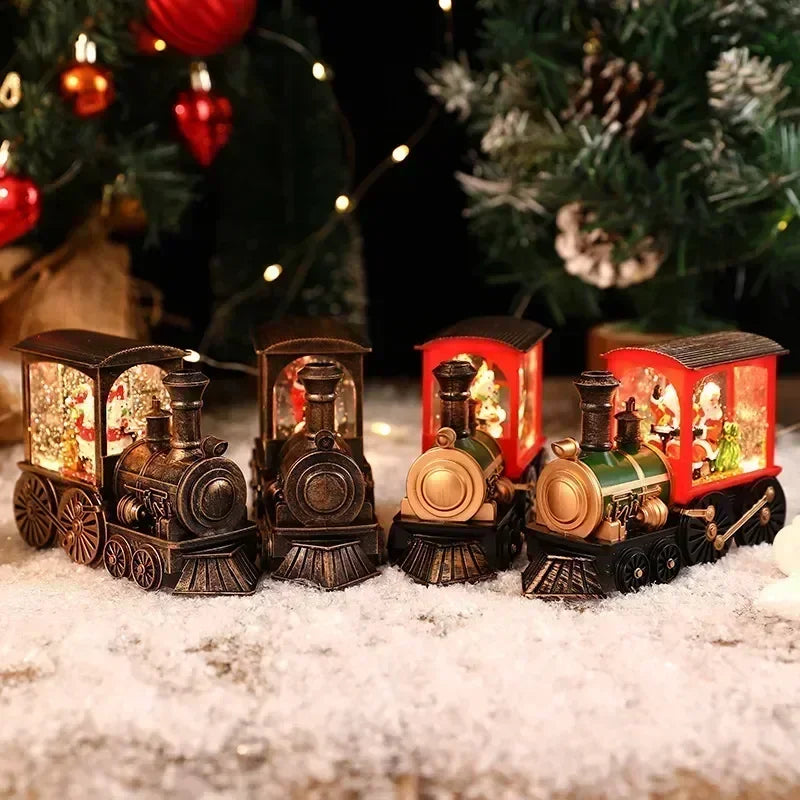 A set of miniature Christmas train music boxes with LED lights and water-filled crystal balls resting on snow.
