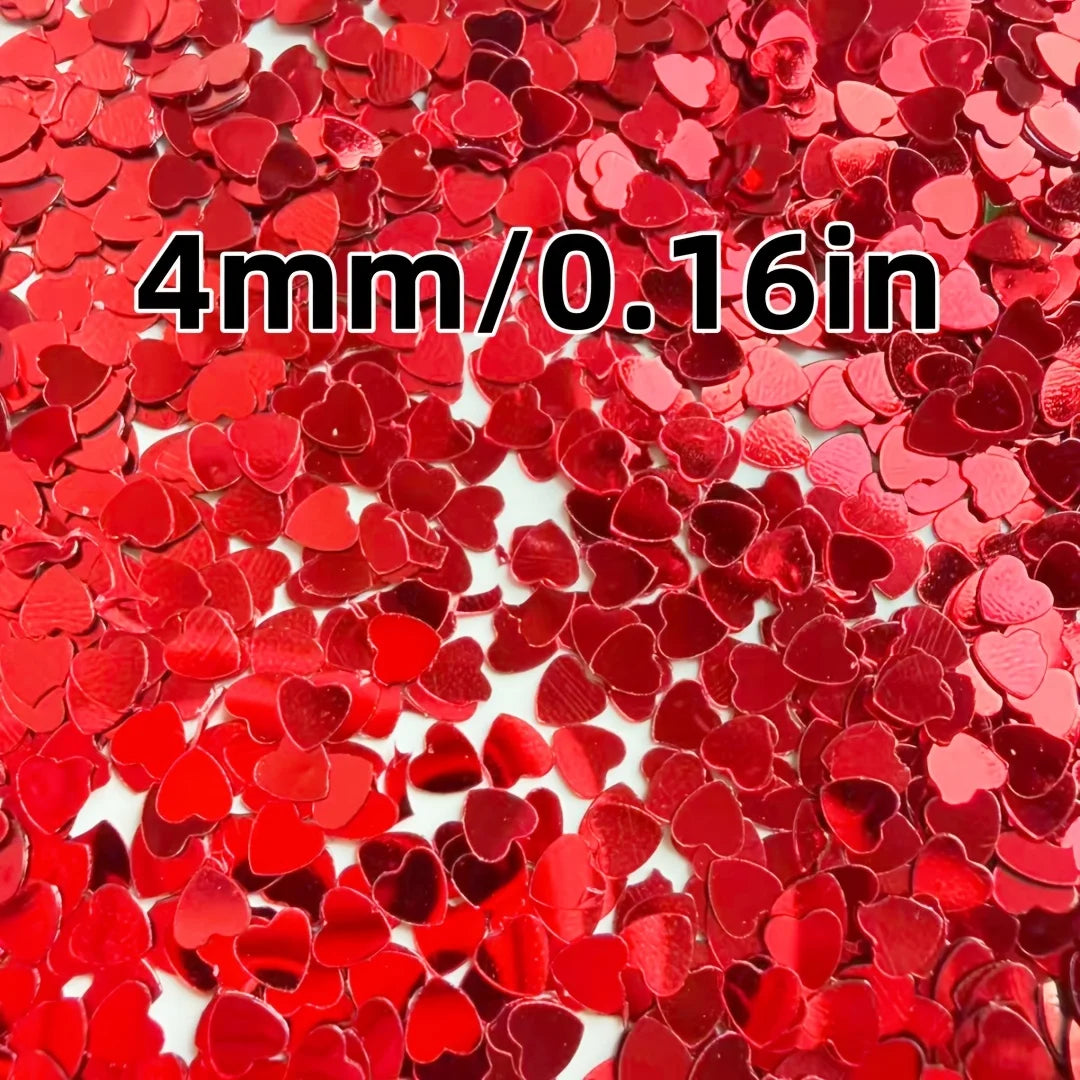 Red heart-shaped foil confetti scattered across a white background for parties and celebrations