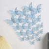 A set of light blue and silver 3D hollow butterfly wall decals displayed on a white wall.