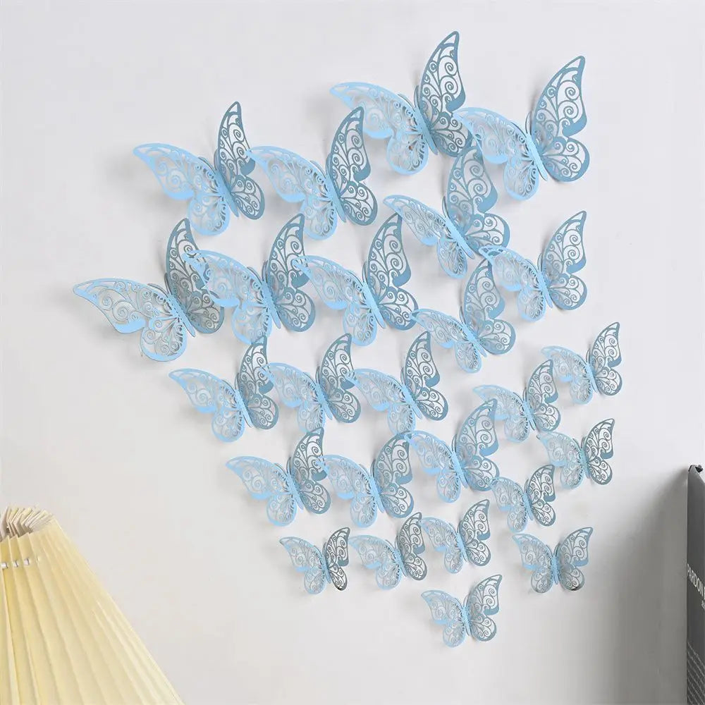A set of light blue and silver 3D hollow butterfly wall decals displayed on a white wall.